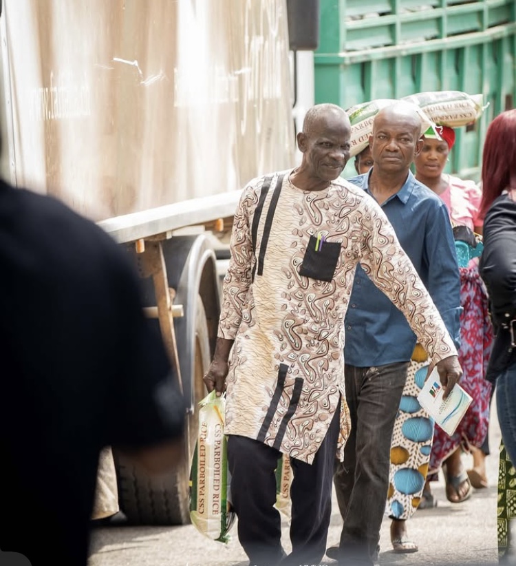 Men leave with their bag of Rice