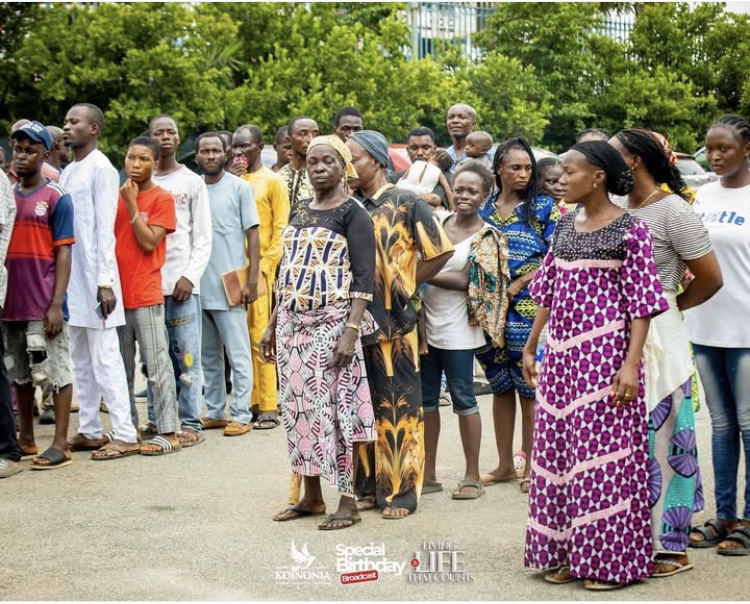 Crowd lined up orderly for bags of Rice