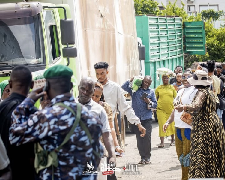 Crowd leaving with their bag of Rice