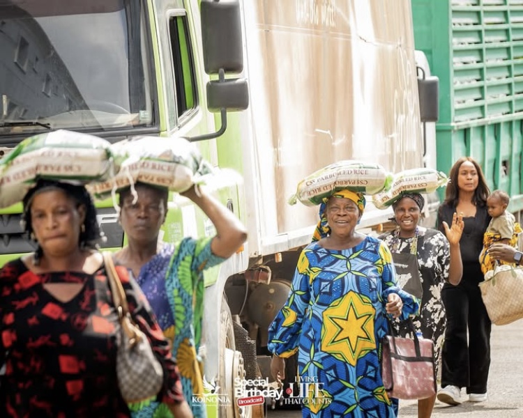 Women leave with their bag of Rice