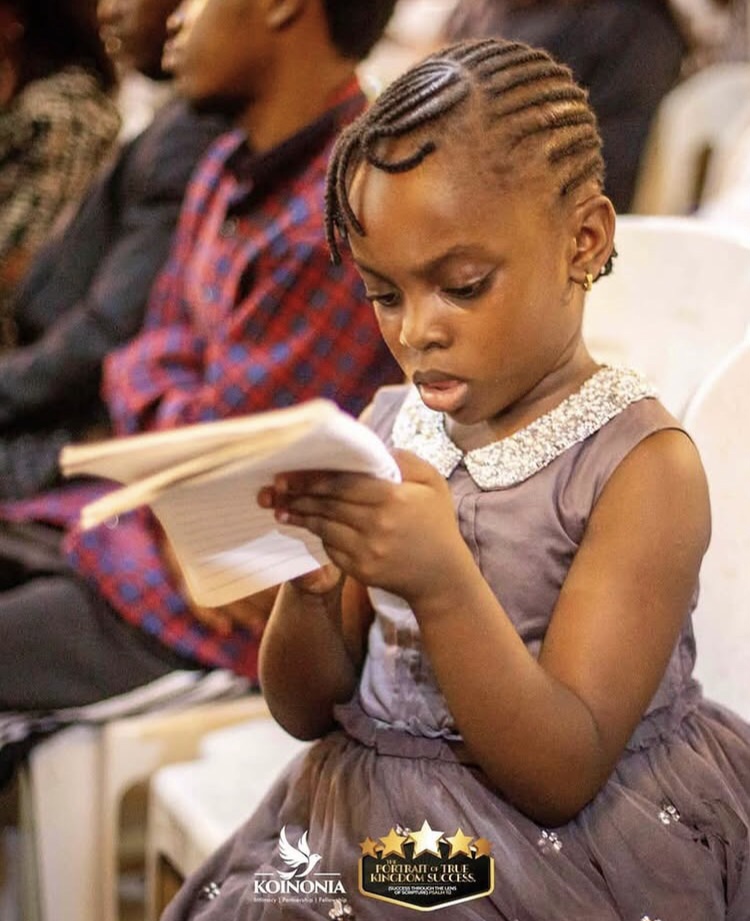 Little girl taking notes
